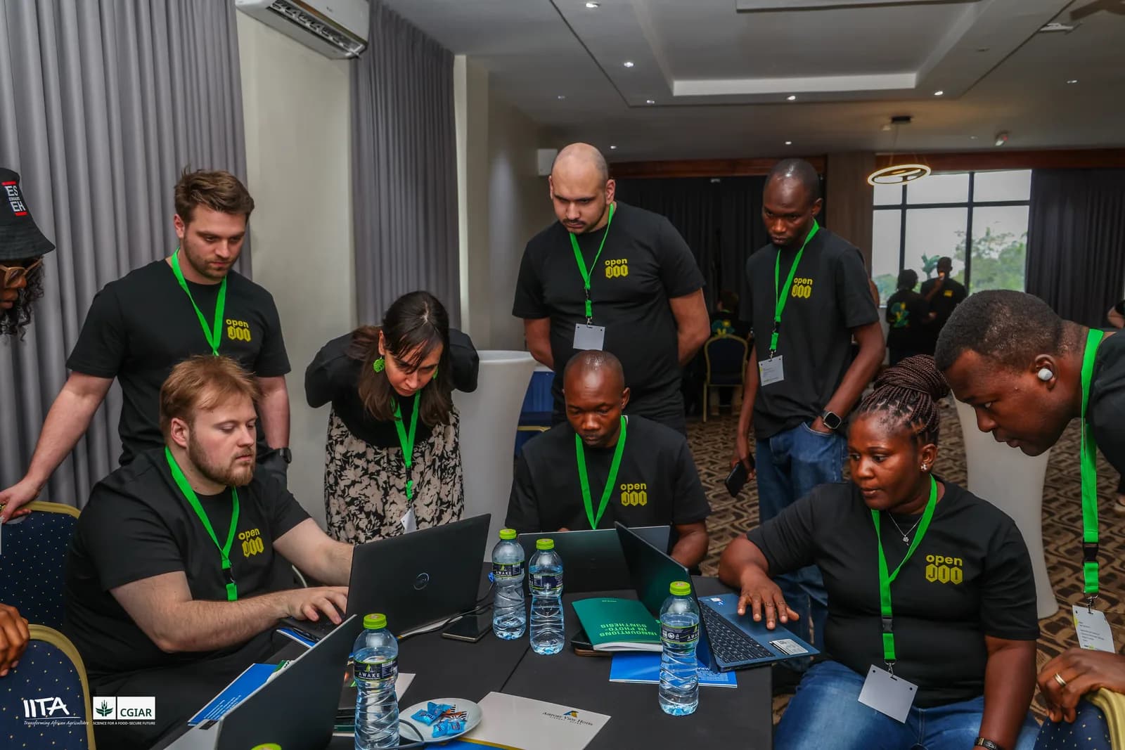 Participants in a focused working session, reviewing time-series traces and notebooks on their laptops